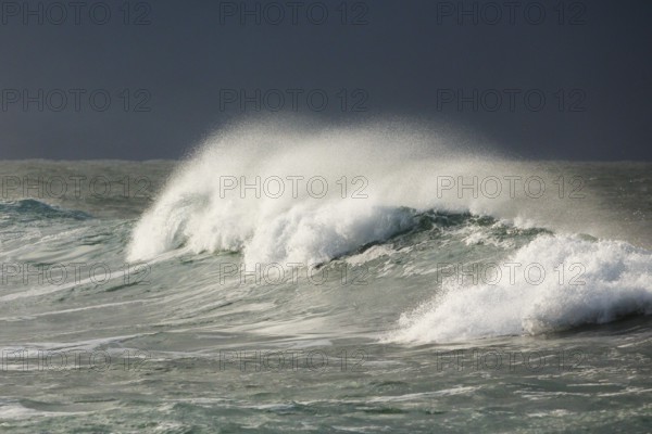 Big wave breaks in the open sea on the Breton coast near Brest, France, Europe