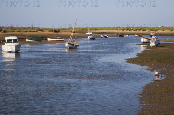Boats in a tidal creek at Burnham Overy Staithe, north Norfolk coast, England, United Kingdom,