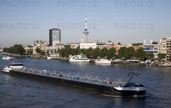 River barge chemical transporter ship 'Tristan' passing Euromast in the city, River Maas, Port of