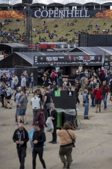 Copenhagen, Denmark - 19 June 2024: Festivalgoers in front of the logo at the Copenhell Metal