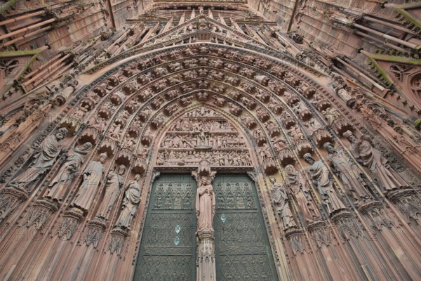 West façade main portal with tympanum and decorations, figures, view upwards, detail, church door,