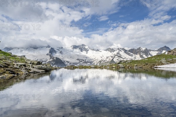 Picturesque mountain landscape with mountain lake, mountains and glaciers reflected in the