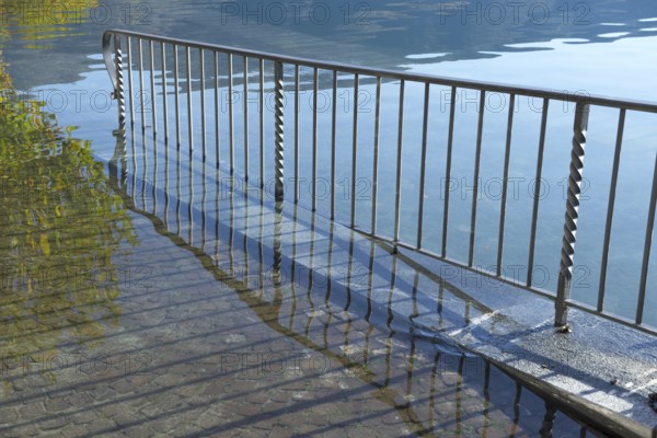 Street with Railing on Flooding lake Maggiore on the Waterfront in a Sunny Day with Sunlight in