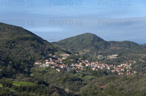 Idyllic view of a village with orange-coloured roofs and lush vegetation, Andritsena,