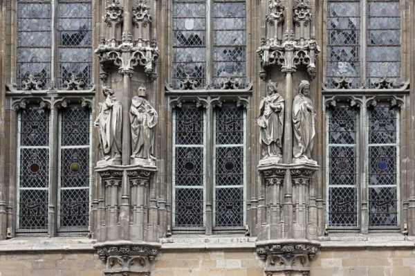 Historic town hall Stadhuis, partial view of the façade in Flamboyant Gothic style with sculptures,