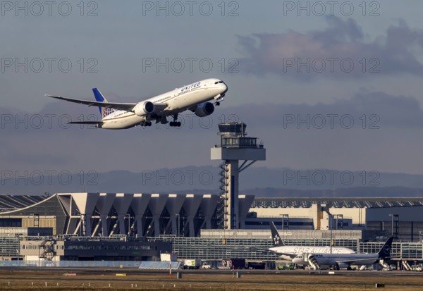 Aircraft taking off in front of the hangar and tower at Fraport Airport. Aircraft registration