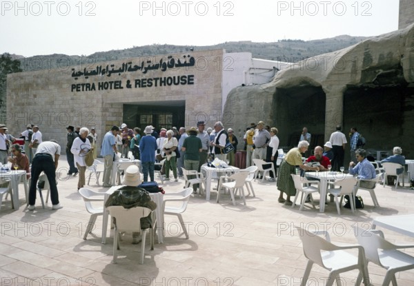 Tourists of a Hellenic tour group in front of a hotel and a service area in Petra, Jordan, 1998,