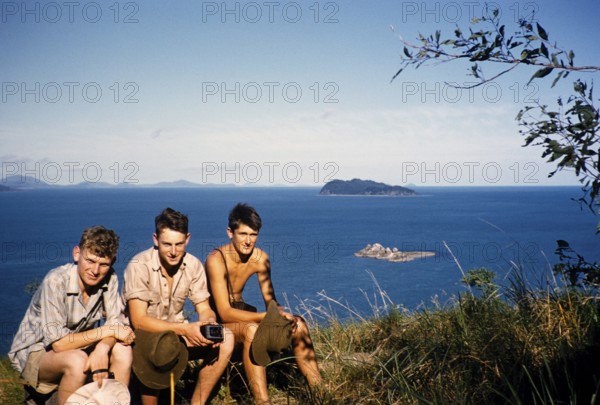 Melbourne Grammar School expedition to Queensland, Australia, 1956 three boys sit on the shore
