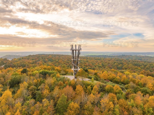 Imposing tower rises above the colourful autumn forest under a vibrant sky, Schönbuchturm,