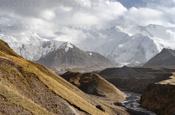 Achik Tash river, Achik Tash valley, behind glaciated and snow-covered mountain peak Pik Lenin,