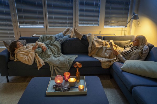 Symbolic image energy saving, cold winter, energy crisis, cold flat, mother and daughter lying on