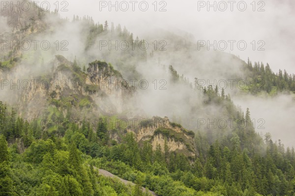 Wisps of mist cover the Karwendel mountains in the Großer Ahornboden nature reserve, Eng Valley,