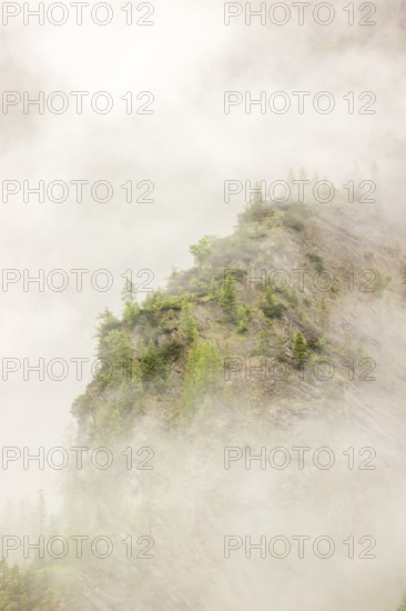 Wisps of mist cover the Karwendel mountains in the Großer Ahornboden nature reserve, Eng Valley,