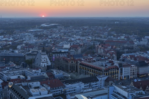 View of the city from the City Tower at sunset, St Thomas' Church, Red Bull Arena and Auwald