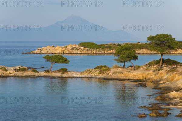 Picturesque bay with tree-covered rocks and mountain views, Karidi beach, Karydi, Mount Athos in