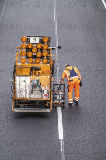 Marking work after the application of new whisper asphalt surface for the A40 motorway, in the