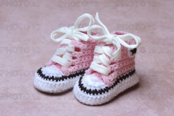 Baby shoes with pink background, handmade