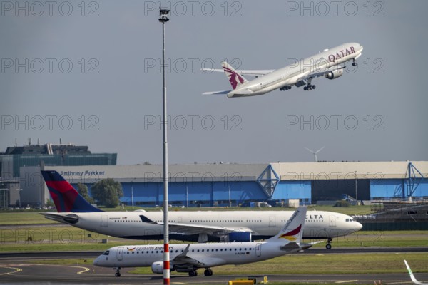 Amsterdam Schiphol Airport, aircraft on the taxiway, Qatar Airways plane takes off from the