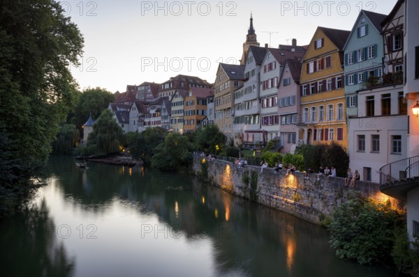 View in summer from the Neckar bridge onto the Neckar front with historic buildings, collegiate