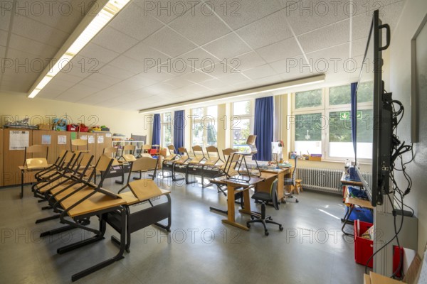 Classroom of a fourth grade, after school, the building is older but in good condition, modern