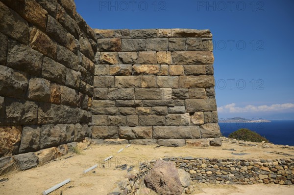 Stone walls of an ancient ruin overlooking the sea under a clear sky, Palaiokastro, Ancient