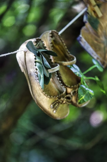 Children's shoes, shoes hanging on a washing line in the woods, vintage, decoration, Lost Gardens