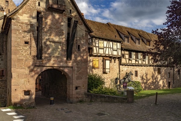 The upper gate La Porte Haute and half-timbered houses of the town wall of Riquewihr, Alsace,