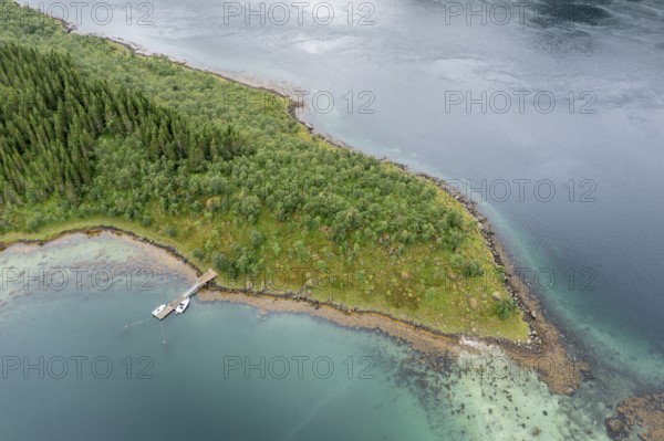 Aerial view of a bay at the Raftsund, single hut with boat, fjord between Lofoten and Vesteralen,