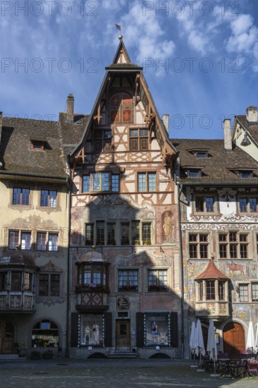 Imposing, historic half-timbered buildings with detailed facade paintings on the market square in