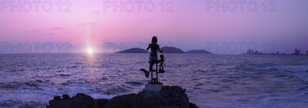 Mexico, statues near Mazatlan sea promenade, El Malecon near tourist beaches and scenic sunset
