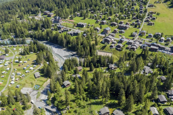 Drone shot, Camp site and village of La Fouly at a glacial river, holiday cottages, Switzerland,
