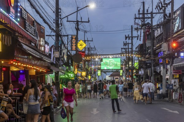 Crowds of people on Bangla Street in the evening. Nightlife on Bangla Walking Street with go-go