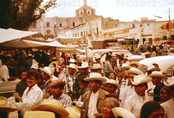 Crowds of people at a local festival in a small market town, Puebla state, Mexico 1961