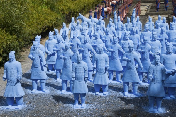 Many blue terracotta warrior statues stand on a path and appear to be in formation, Bacalhôa,