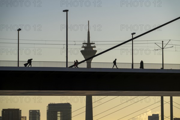 Pedestrians on the Oberkassler Rhine Bridge, Rhine Tower, behind the Rheinknie Bridge, Düsseldorf,