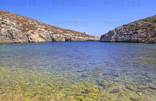 Shoreline clear blue sea water, Mgarr ix-Xini coastal inlet, island of Gozo, Malta, Europe