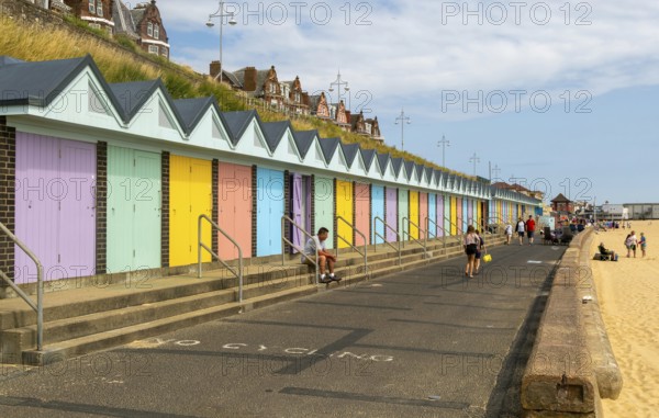 Colourful beach huts and promenade footpath, South Beach, Lowestoft, Suffolk, England, UK