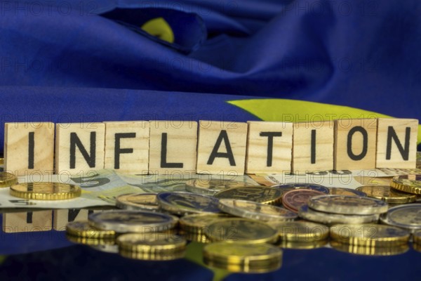 Symbolic image of inflation (in the euro area) : The word INFLATION in letter cubes on euro coins