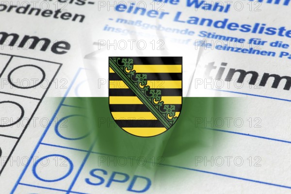 Symbolic image of state election in Saxony: Flag of Saxony and close-up of a ballot paper. The next