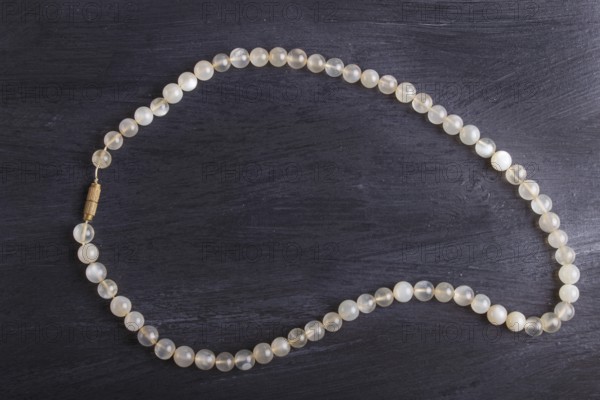 Agate colored beads on a black background. top view, close up