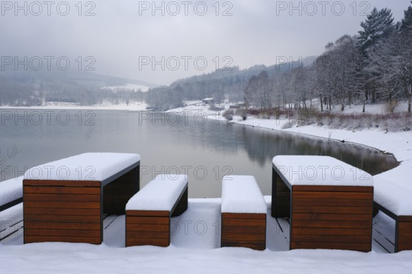 Rest area with snow-covered benches at the Hennesee, Hennetalsperre, Naturpark