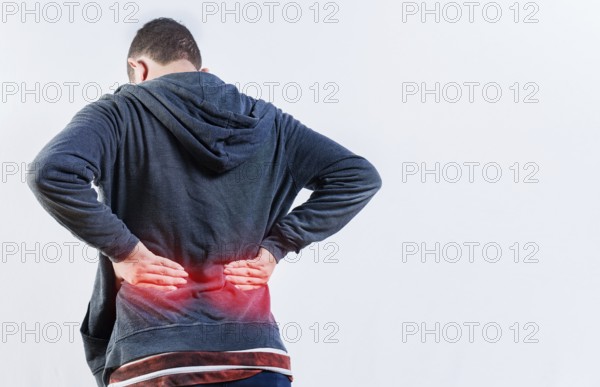 Back view of person with back ache isolated. Lumbar problems concept. Male person with spine
