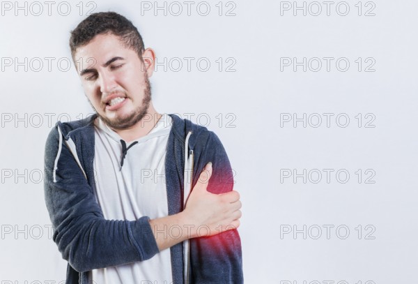 Unhappy man with arms muscle pain isolated. Sore young man with arms pain isolated