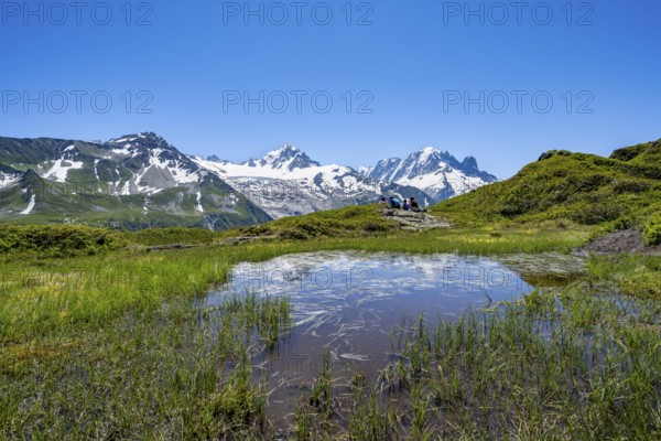 Small mountain lake, mountain panorama with glaciated peaks, Aiguille Verte and Glacier du Tour,