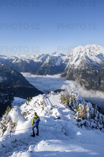 Tourist on a hiking trail, Snow-covered summit of the Jenner with viewing platform in autumn, view