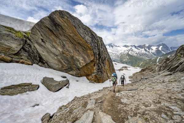 Mountaineer on a hiking trail next to a large boulder, ascent to the Nördliche Mörchnerscharte,