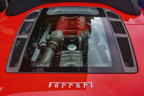 View of transparent bonnet and engine of sports car Ferrari F 430 F430 Spider in colour Corsa Rosso