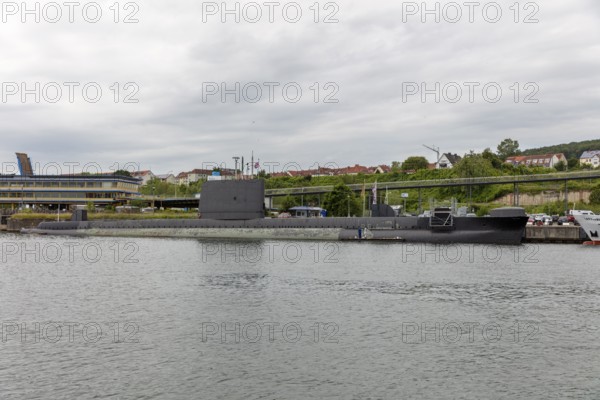 Submarine at the harbour with city in the background under a cloudy sky, Rügen