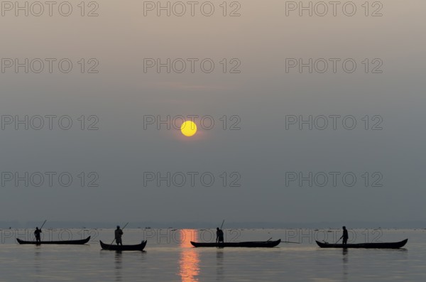 Fishermen on the Vembanad Lake at sunrise, Kerala, South India, India, Asia