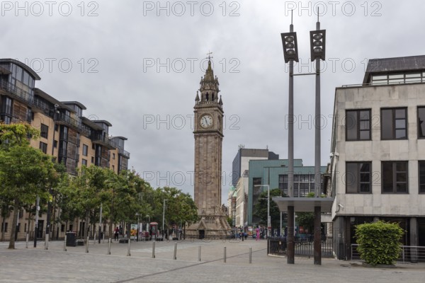 Historic clock tower in a public square surrounded by modern urban architecture, Belfast
